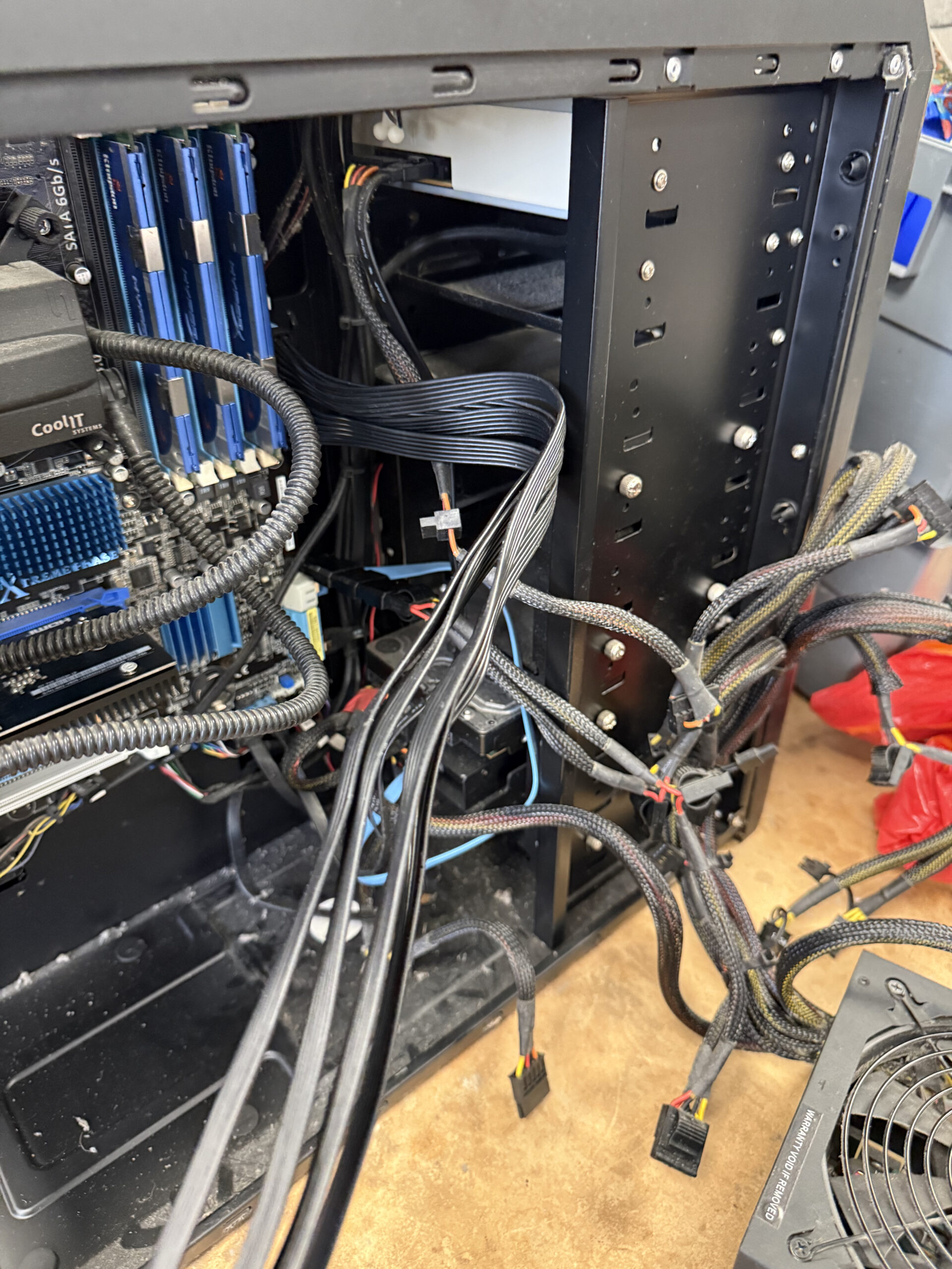 Open desktop PC case with internal cables exposed during workshop diagnostics