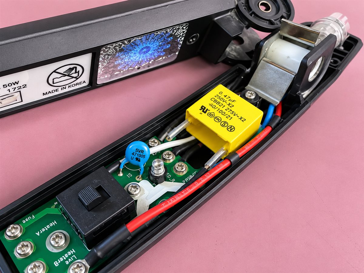 Opened GHD hair straighteners showing the internal circuit board at iPhoneBits in Glengormley.