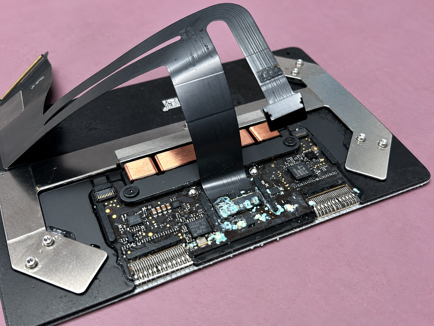 Liquid-damaged MacBook Air A2337 trackpad assembly removed at iPhoneBits in Glengormley