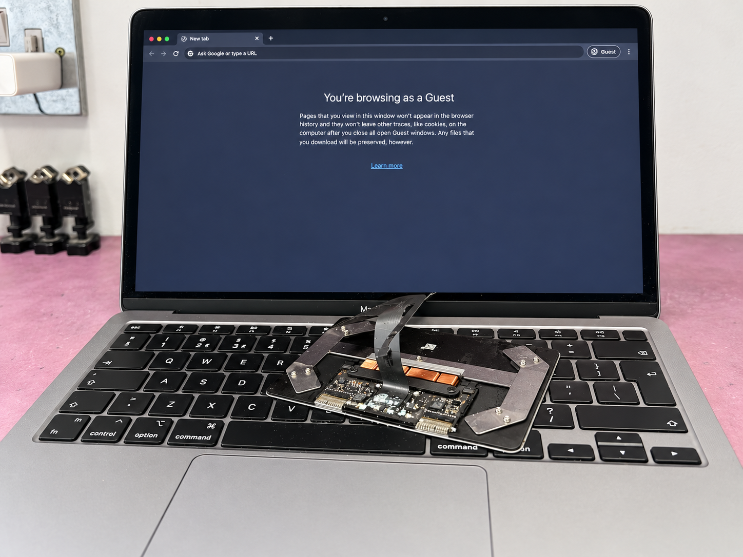 MacBook Air A2337 running at iPhoneBits in Glengormley, with the removed liquid-damaged trackpad shown