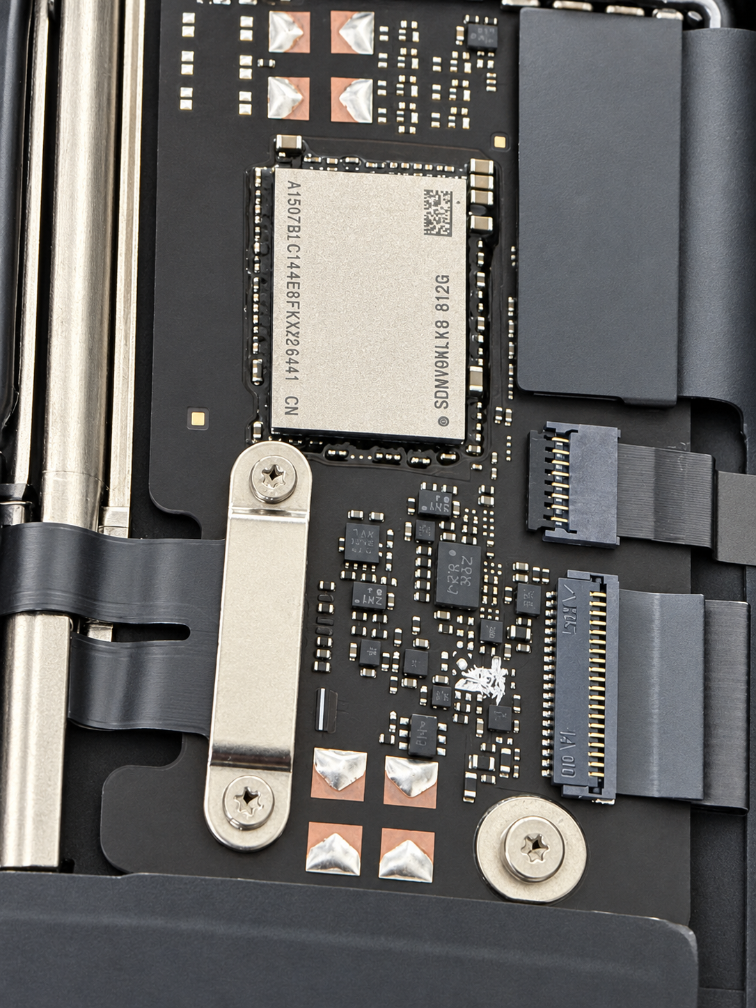 MacBook Neo NAND storage chip on the logic board at iPhoneBits