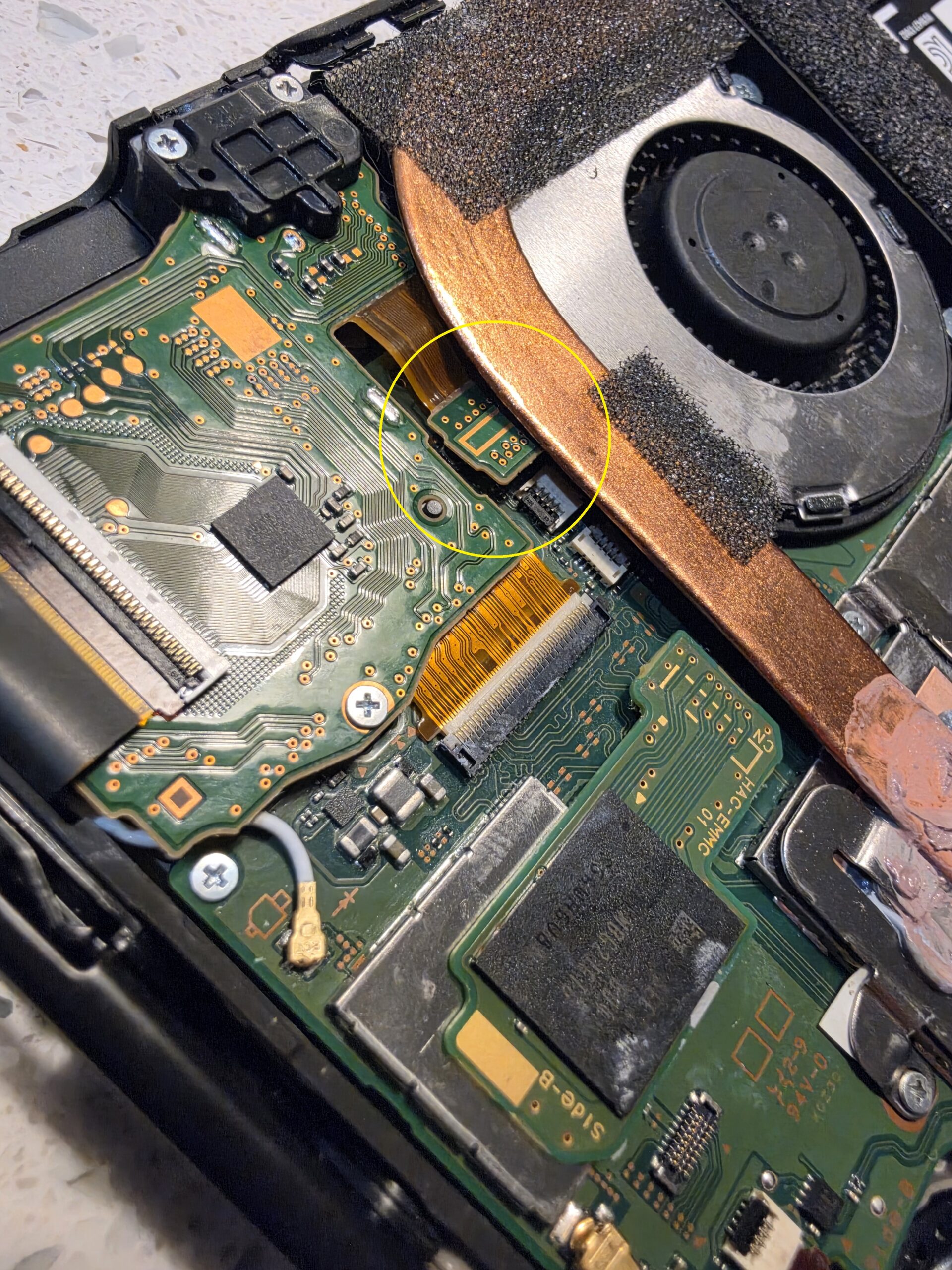 Nintendo Switch touchscreen not working: incorrectly seated internal connection circled during inspection