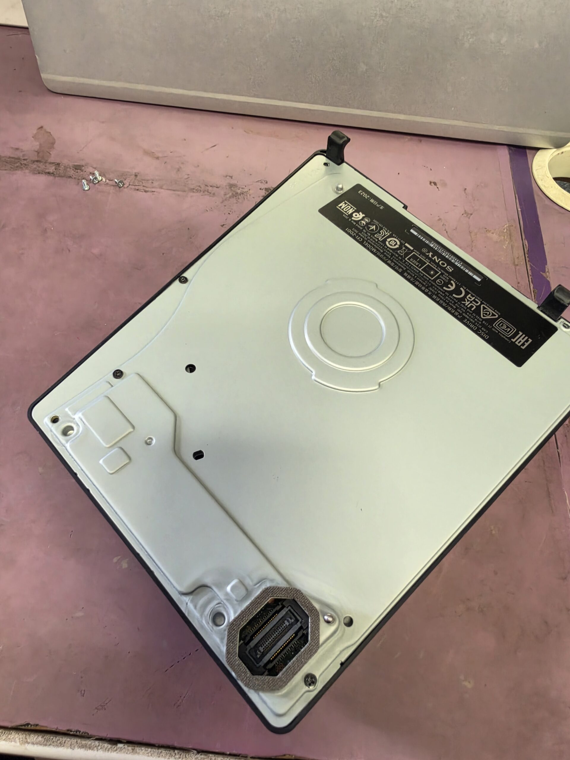 PS5 Slim CFI-2016 removable disc drive on the iPhoneBits workshop bench